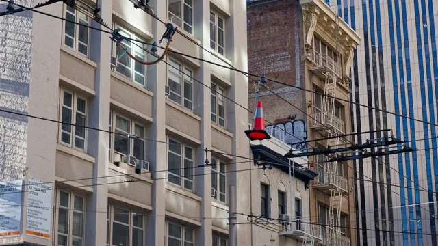 Orange cone beside a coiled black cable